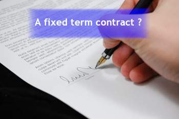 image of a person writing on a contract and a banner stating A fixed trem contract?