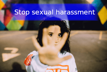 Girl with hand blocking her face and banner with the words " stop sexual harassment"