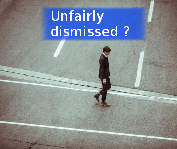 person walking in street and banner stating unfairly dismissed ?